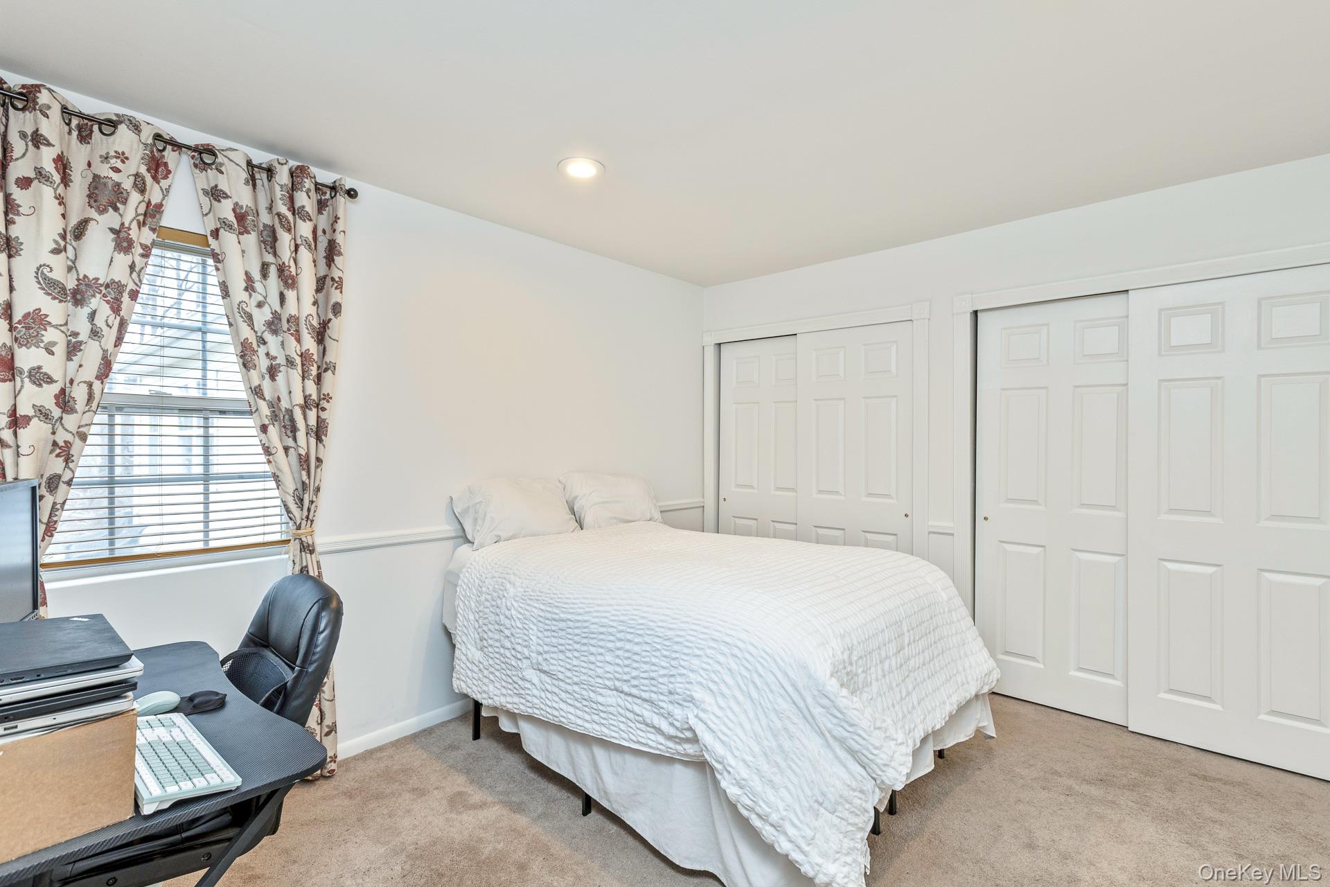 7 Possum Path Coram, NY 11727 - Photo 14 of 22 a bedroom with a bed and a couch