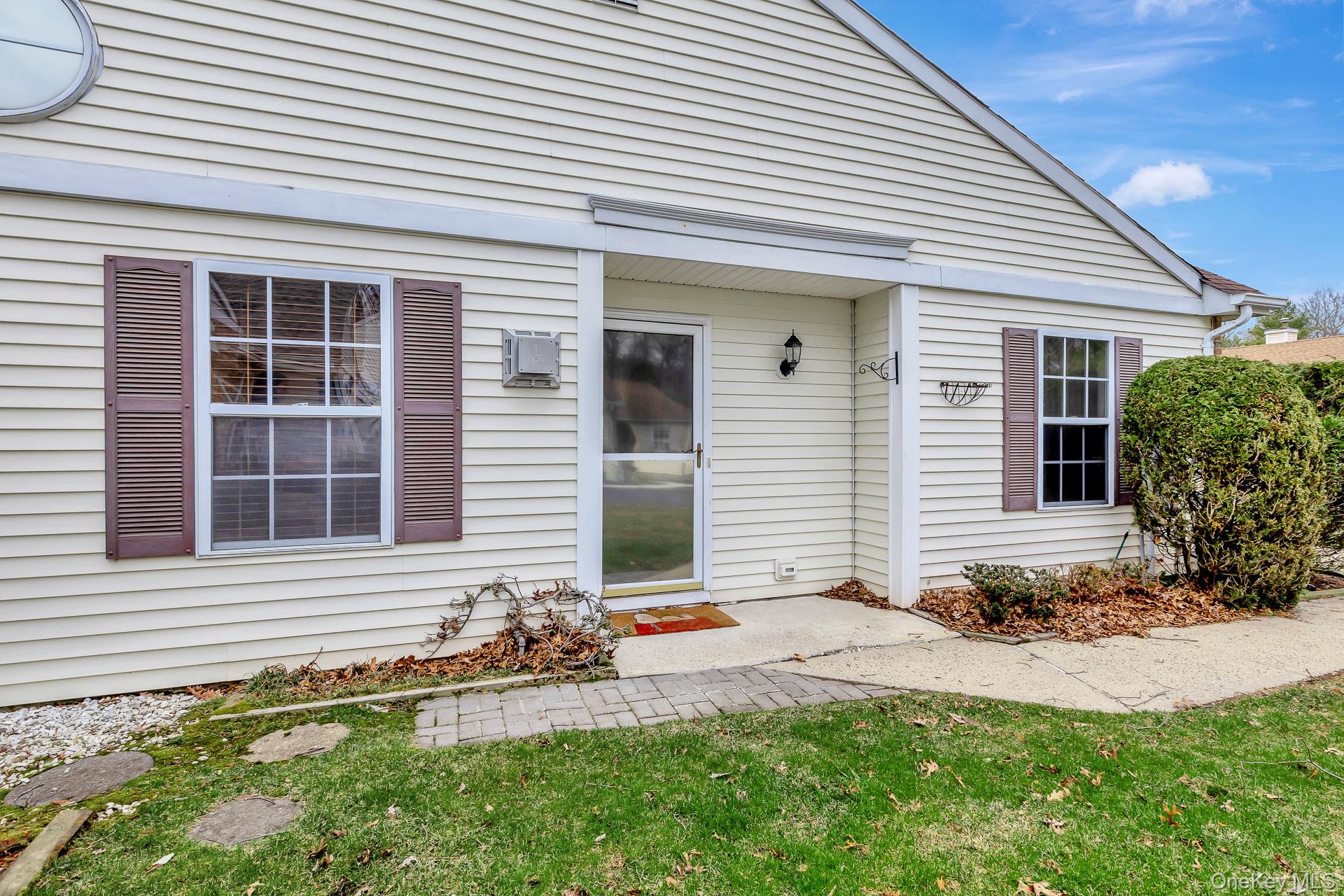 7 Possum Path Coram, NY 11727 - Photo 4 of 22 a front view of a house with a yard