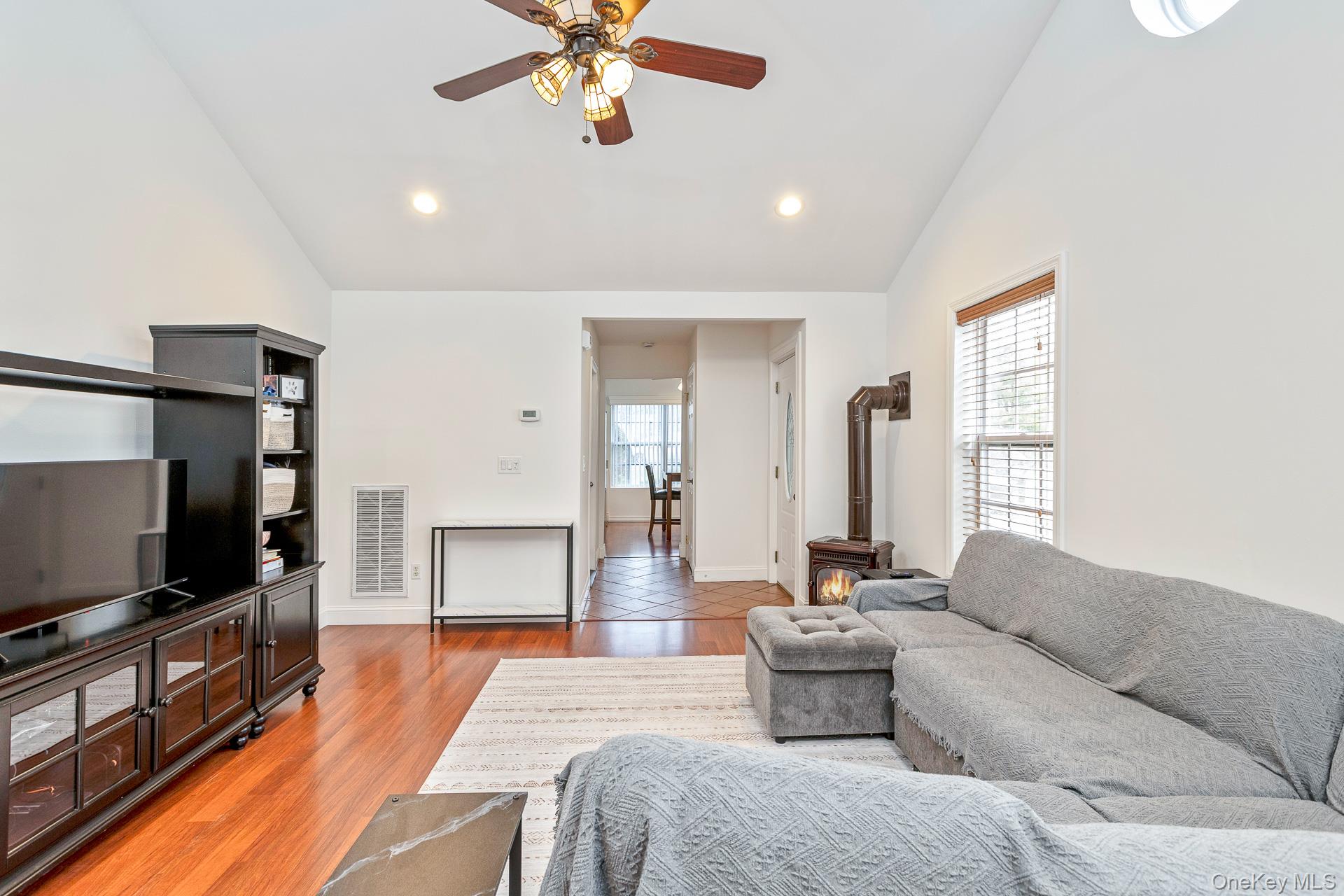 7 Possum Path Coram, NY 11727 - Photo 6 of 22 a living room with furniture and a flat screen tv