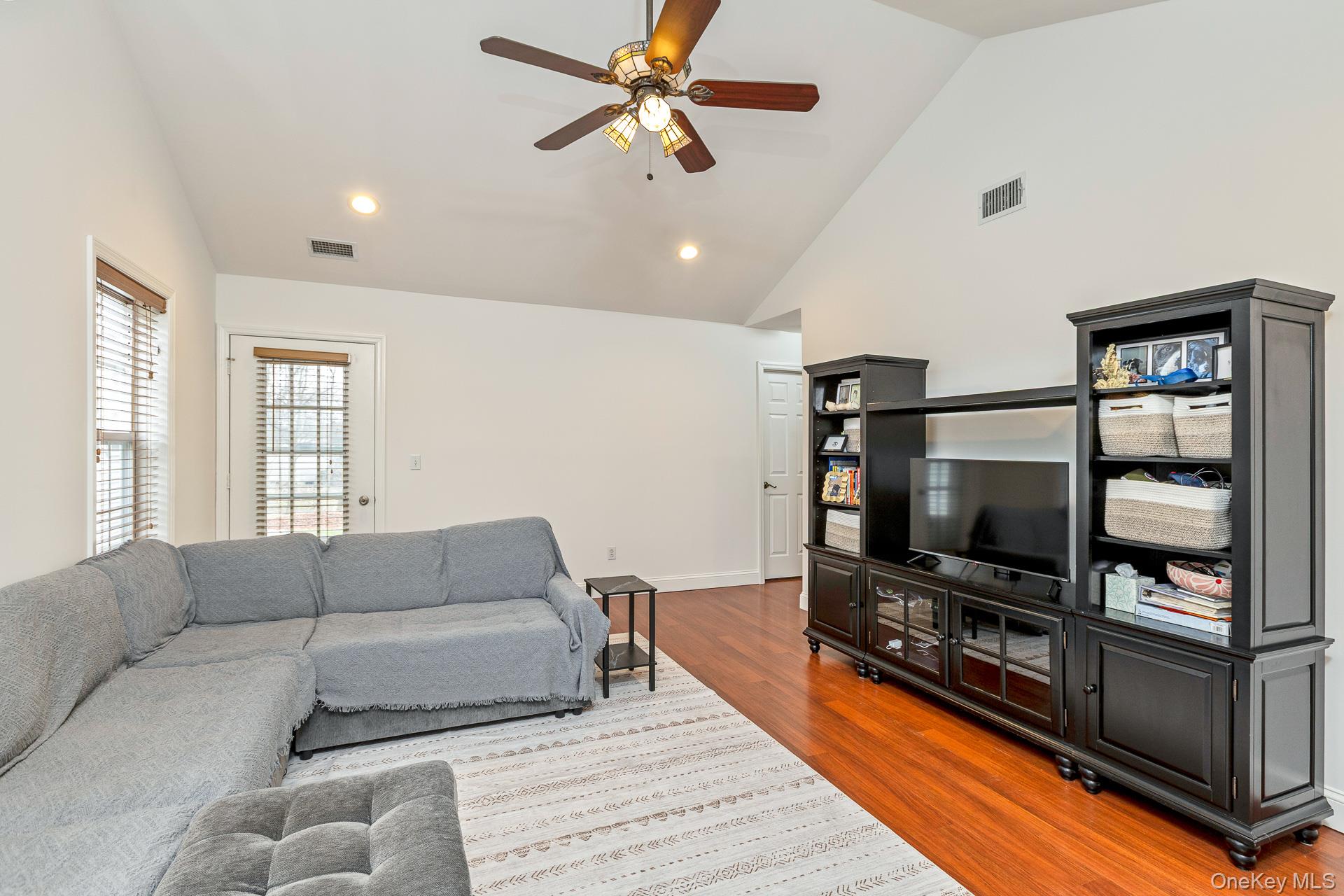 7 Possum Path Coram, NY 11727 - Photo 8 of 22 a living room with furniture and a flat screen tv