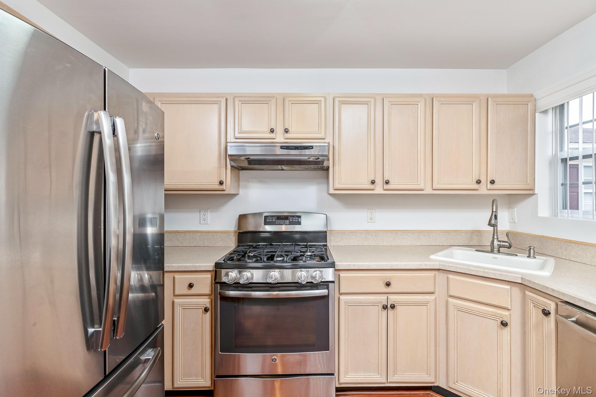 7 Possum Path Coram, NY 11727 - Photo 10 of 22 a kitchen with stainless steel appliances granite countertop a refrigerator sink and stove