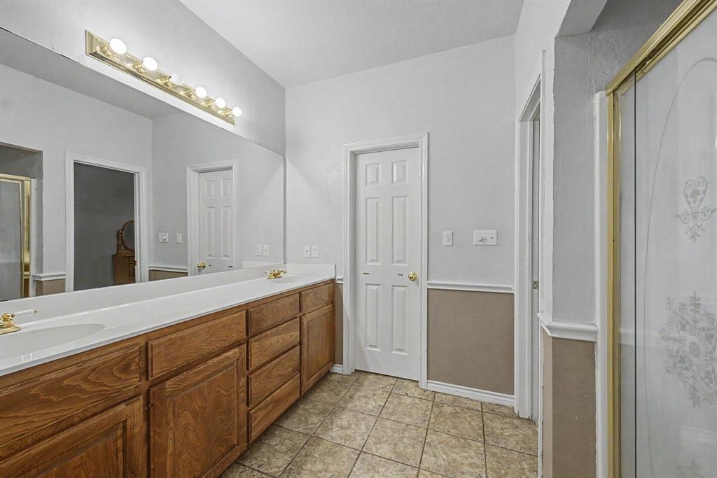 483 Christy Kay Lane Rhome, TX 76078 - Photo 17 of 40 a spacious bathroom with a double vanity sink and a mirror