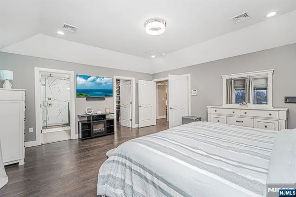 a bedroom with a bed and a television