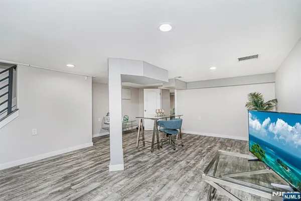 an entryway with furniture and wooden floor