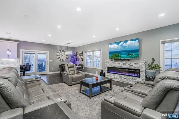 a living room with fireplace furniture and a flat screen tv