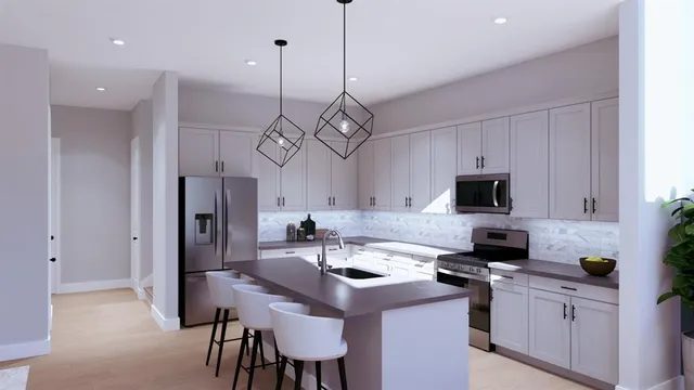 a kitchen with stainless steel appliances a sink a stove a refrigerator a center island a stove and a cabinets