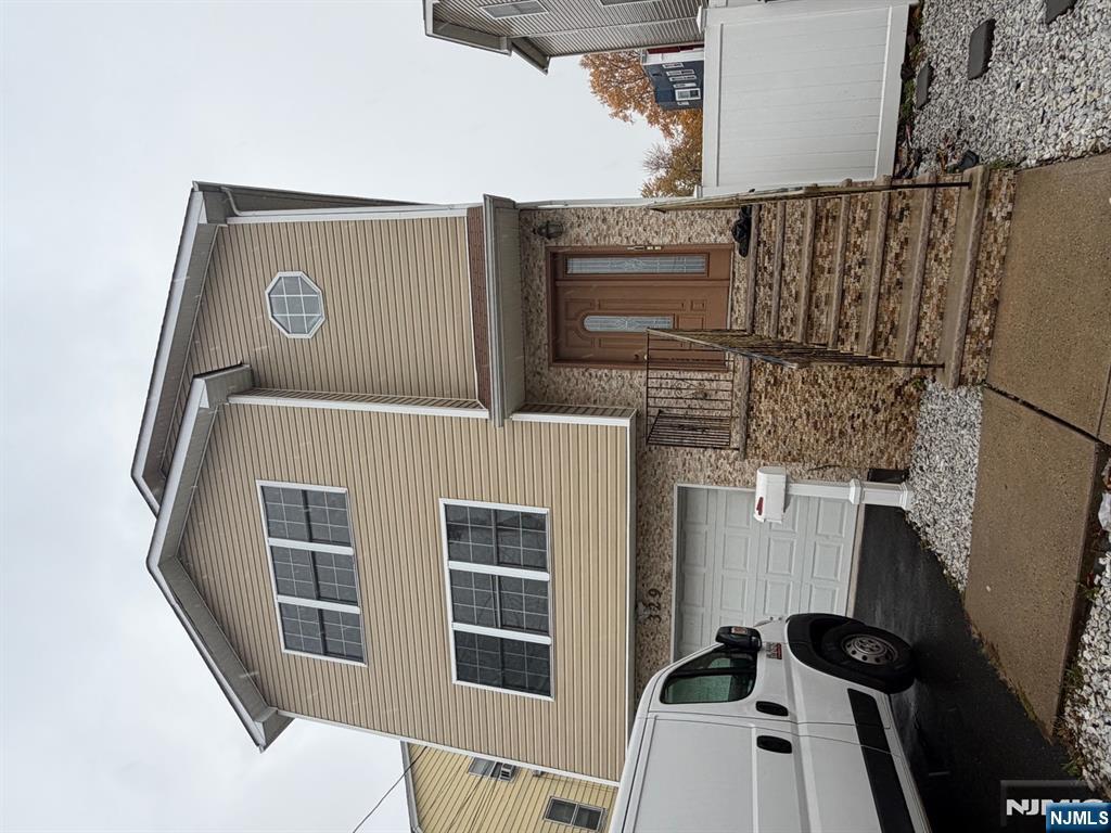 329 Fair Street, Unit 329 Paterson, NJ 07501 - Photo 1 of 14 a front view of a house with garage