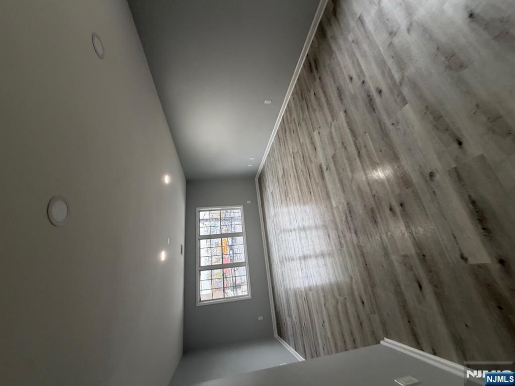 329 Fair Street, Unit 329 Paterson, NJ 07501 - Photo 12 of 14 an empty room with wooden floor and windows