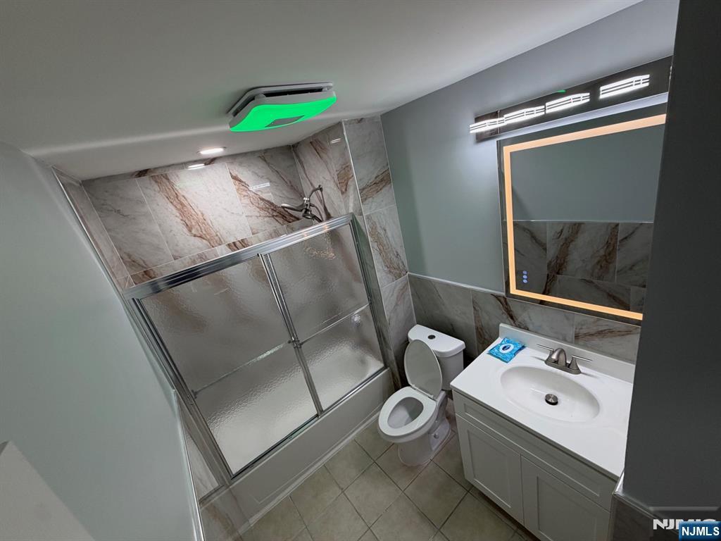 329 Fair Street, Unit 329 Paterson, NJ 07501 - Photo 13 of 14 a bathroom with a sink mirror and toilet