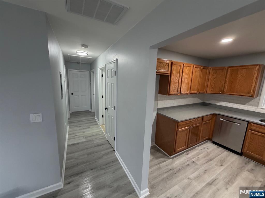 329 Fair Street, Unit 329 Paterson, NJ 07501 - Photo 5 of 14 a kitchen with granite countertop wooden cabinets a sink and a refrigerator