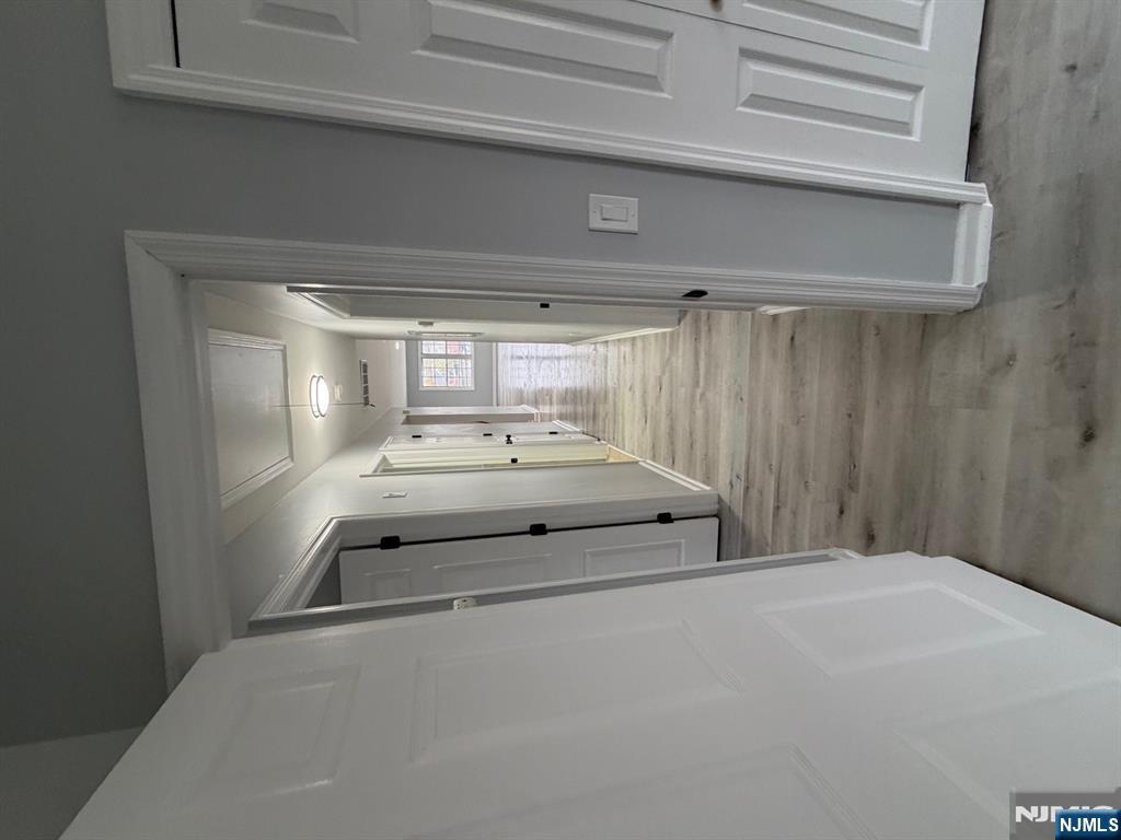 329 Fair Street, Unit 329 Paterson, NJ 07501 - Photo 8 of 14 a view of a hallway with wooden floor and staircase