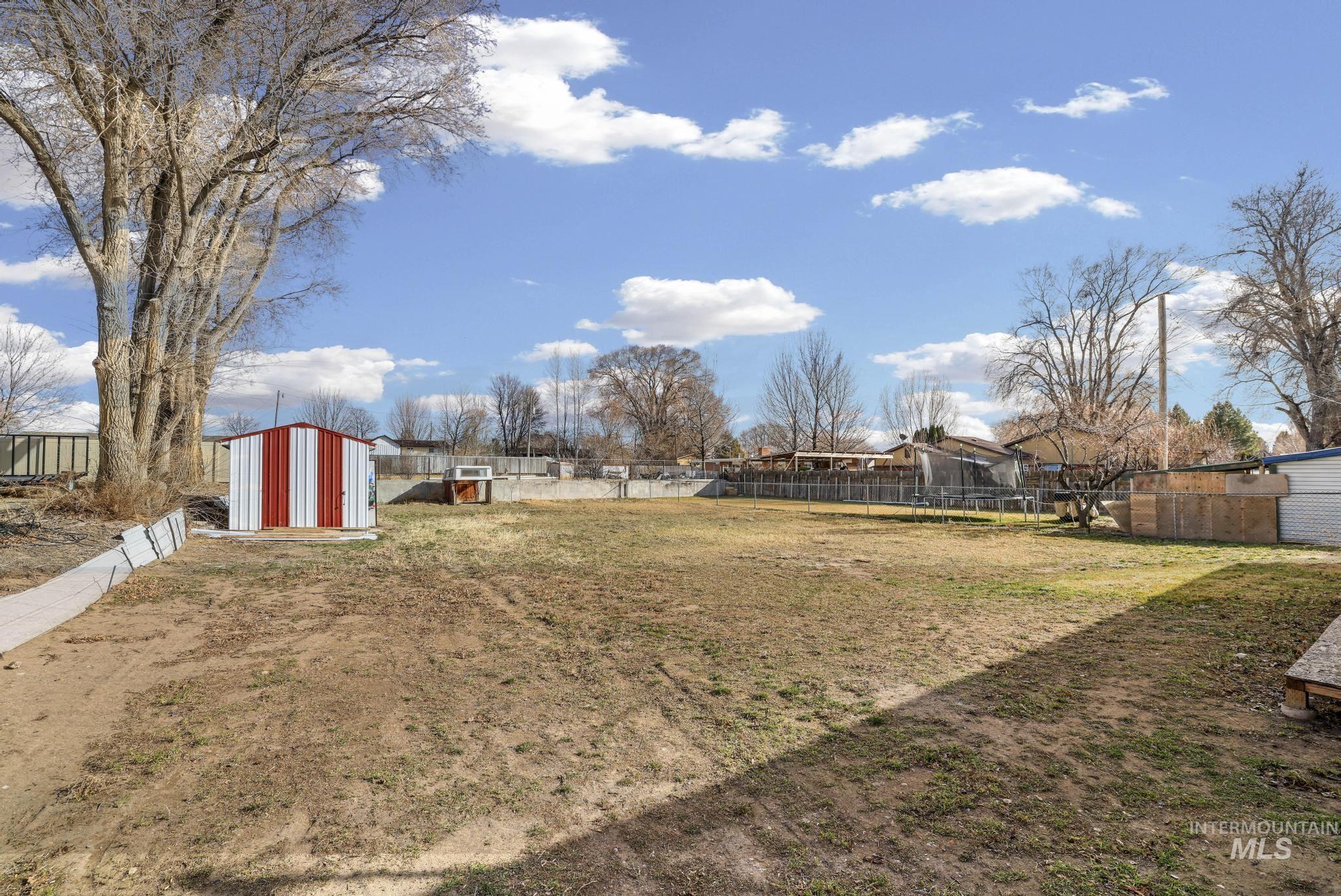 1840 V Street Heyburn, ID 83336 - Photo 19 of 45 Fenced backyard featuring a storage unit