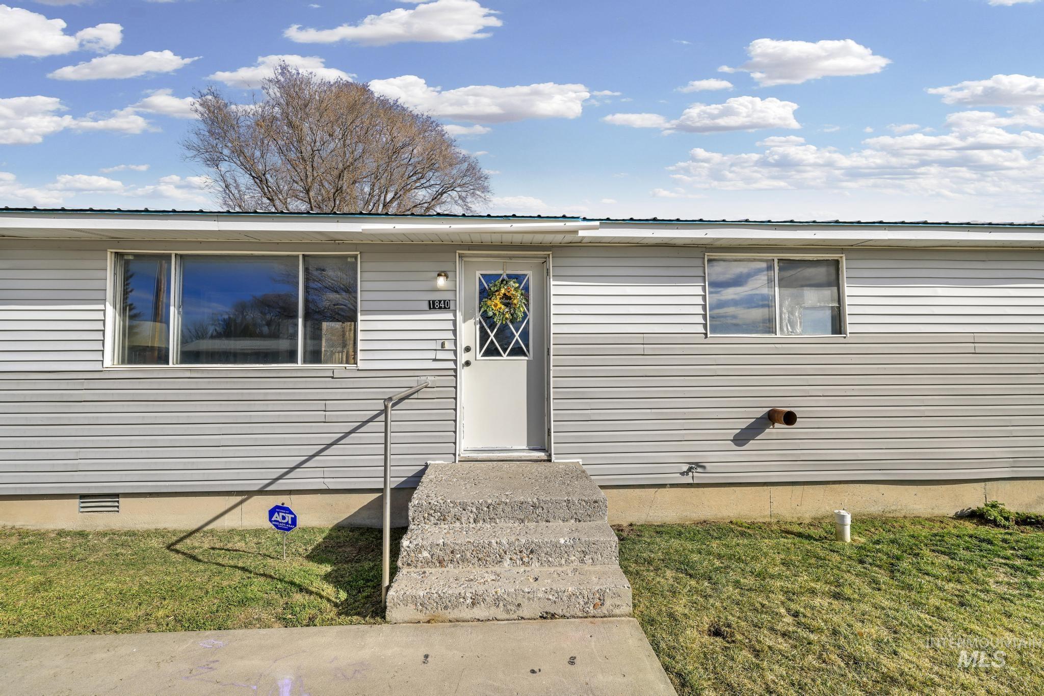 1840 V Street Heyburn, ID 83336 - Photo 2 of 45 Ranch-style house with crawl space, a metal roof, entry steps, and a front yard