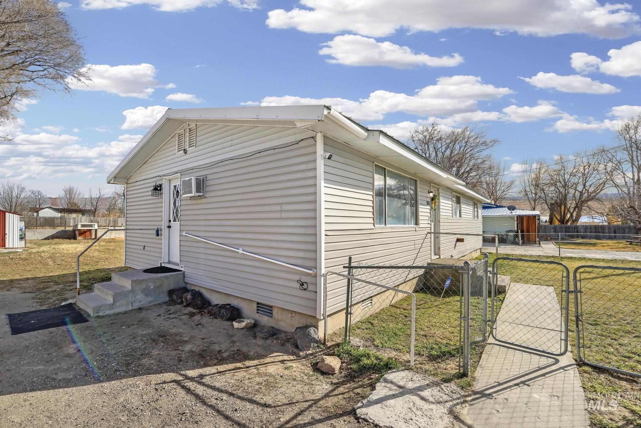 1840 V Street Heyburn, ID 83336 - Photo 23 of 45 View of home's exterior with crawl space and a gate