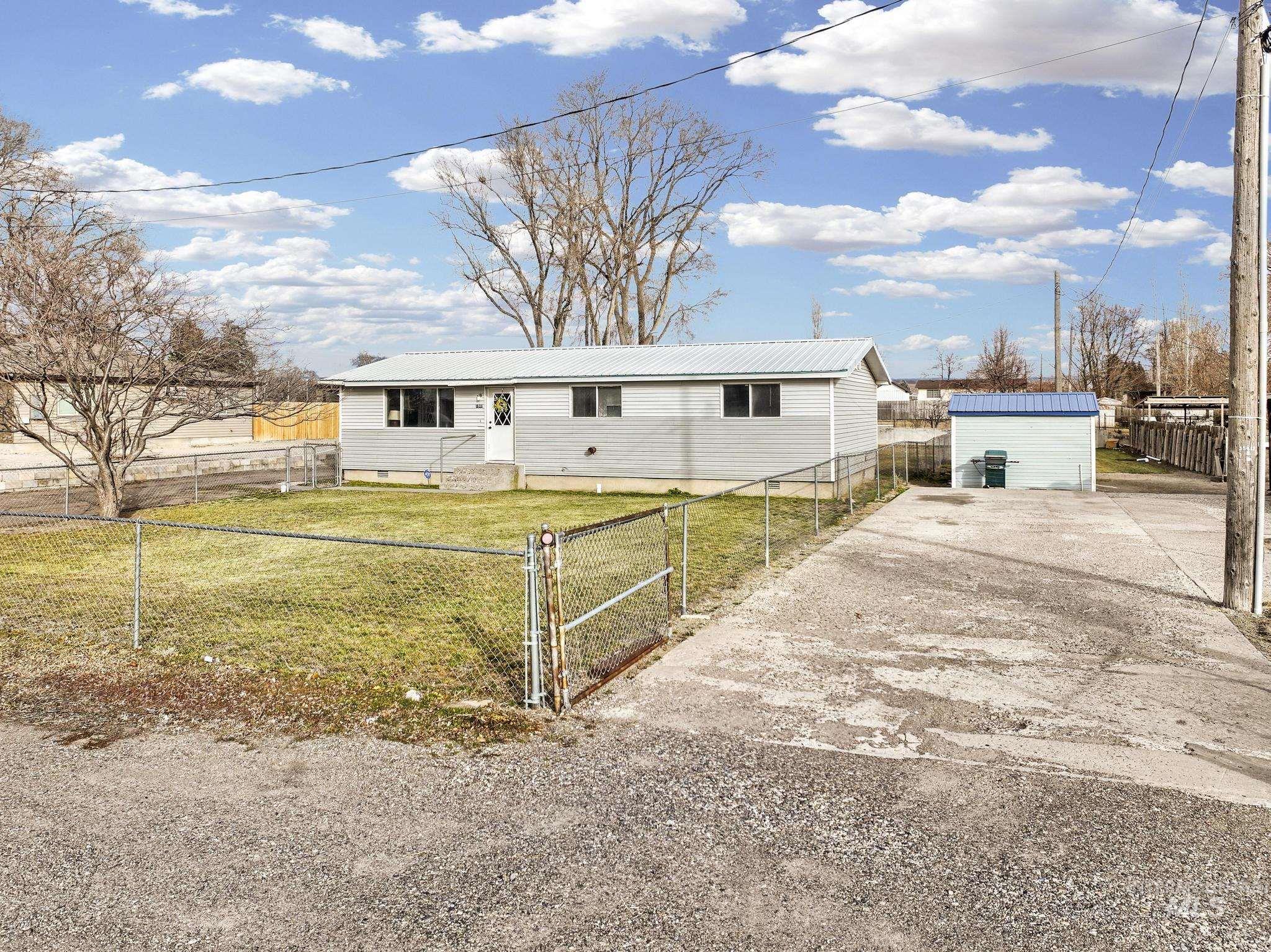 1840 V Street Heyburn, ID 83336 - Photo 28 of 45 View of front of property with a metal roof, a fenced front yard, crawl space, and driveway