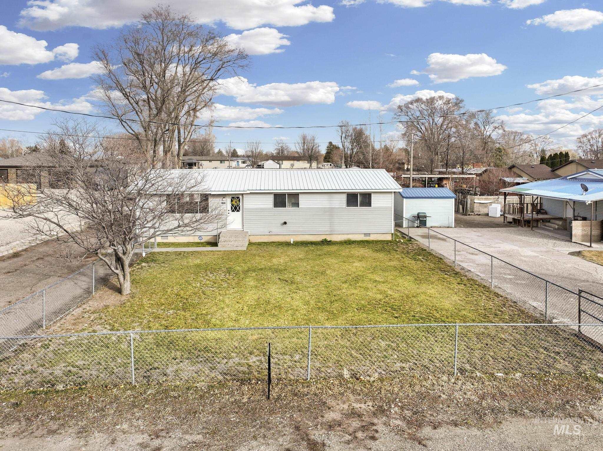 1840 V Street Heyburn, ID 83336 - Photo 29 of 45 View of front facade featuring a metal roof and a fenced backyard