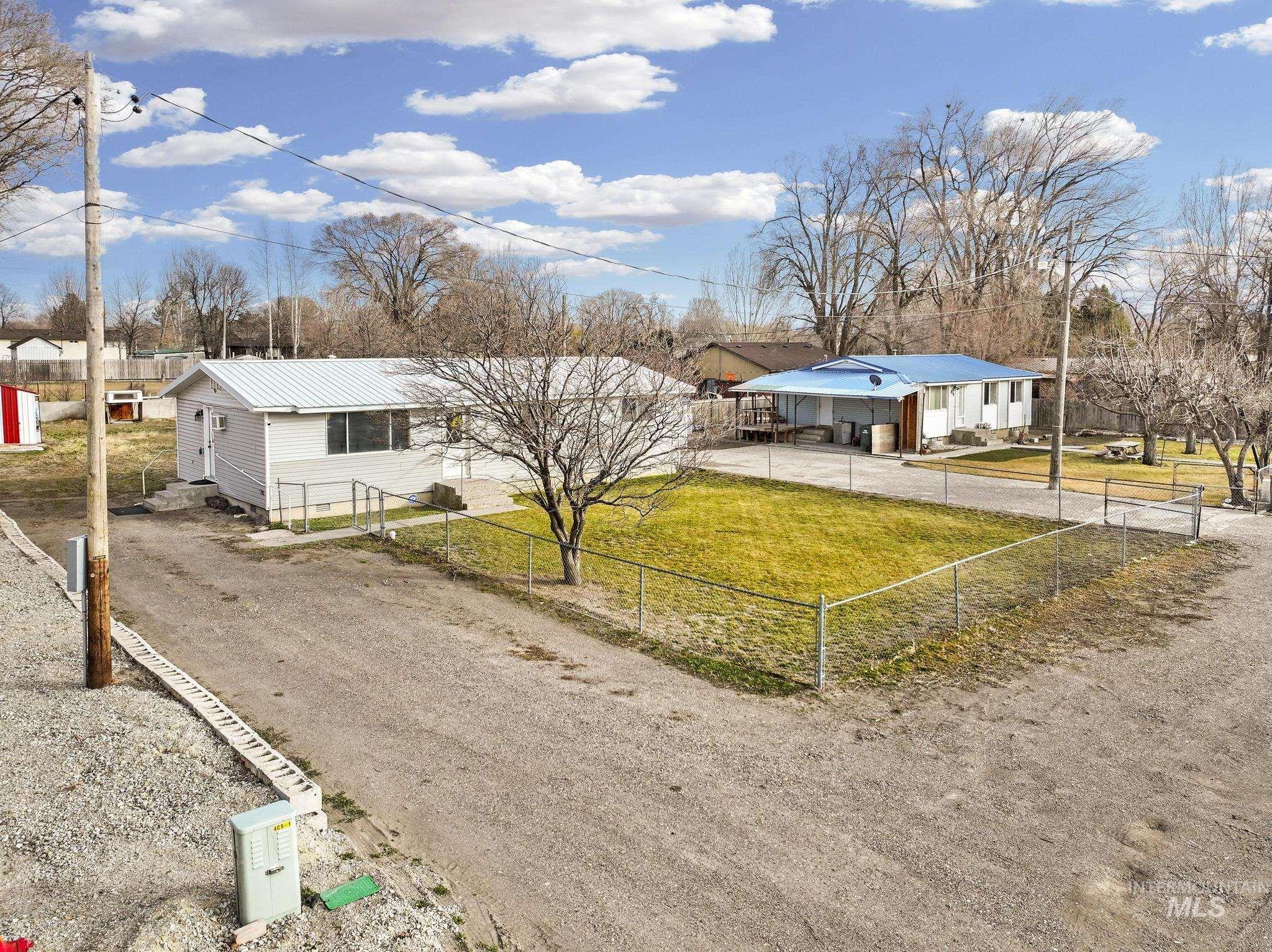 1840 V Street Heyburn, ID 83336 - Photo 30 of 45 View of front of house with driveway, a metal roof, and a fenced front yard