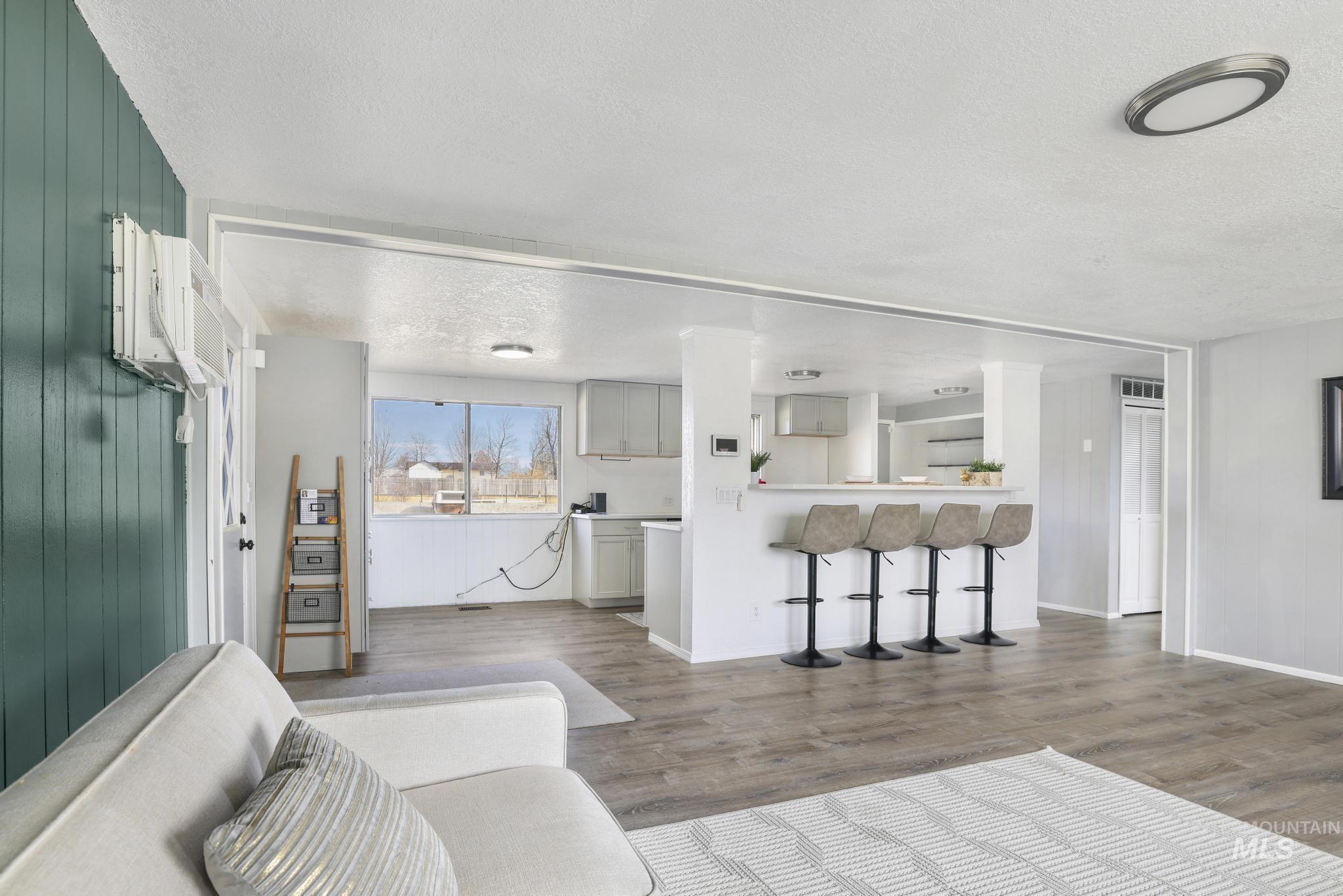 1840 V Street Heyburn, ID 83336 - Photo 3 of 45 Living room with dark wood-style floors and a textured ceiling