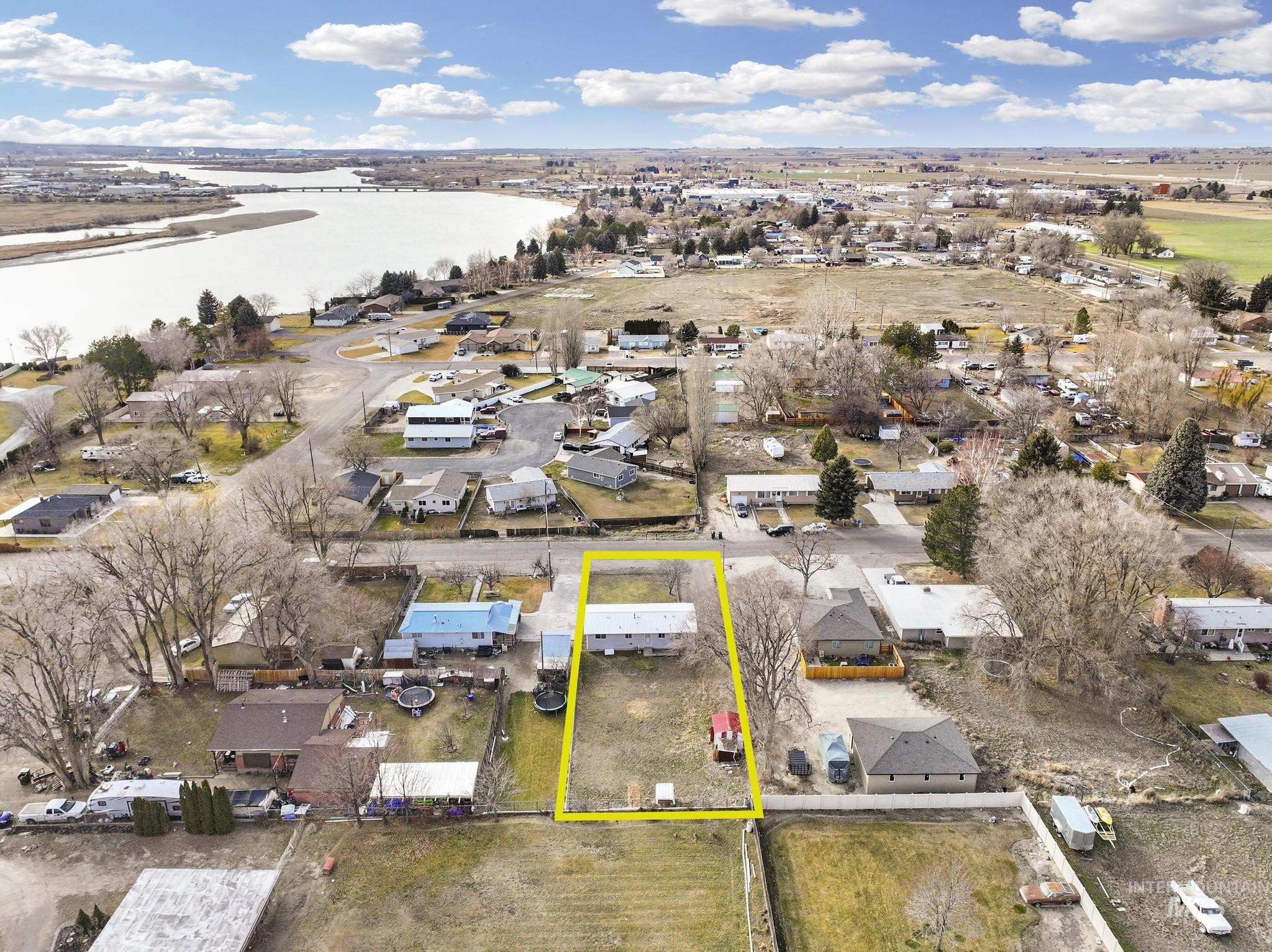 1840 V Street Heyburn, ID 83336 - Photo 42 of 45 Aerial view of residential area with property boundaries highlighted and a nearby body of water
