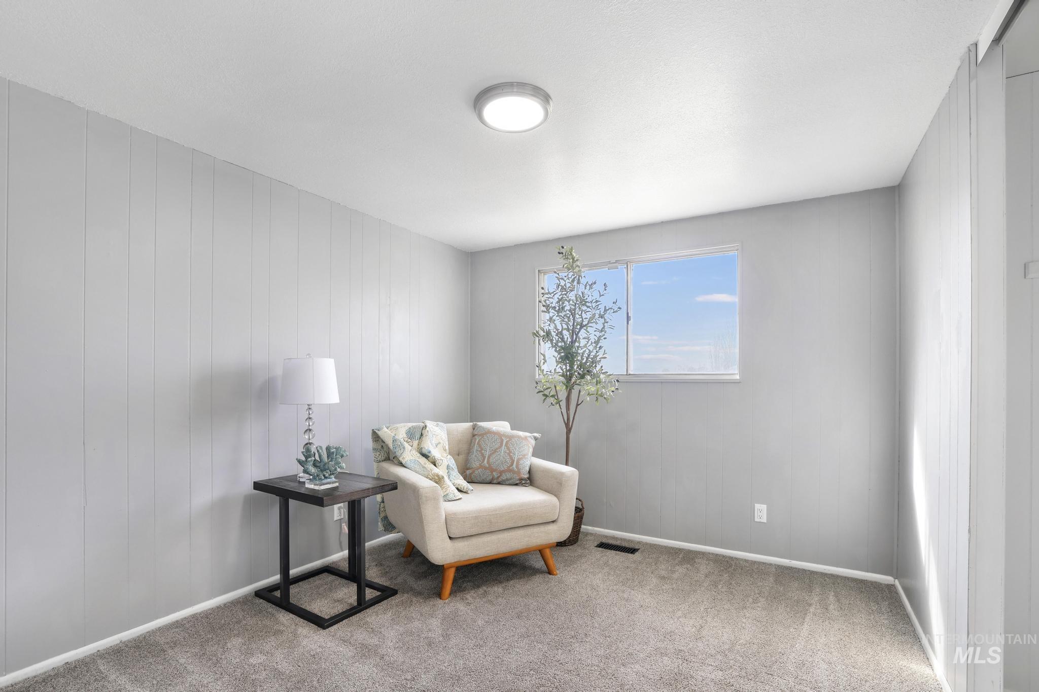 1840 V Street Heyburn, ID 83336 - Photo 10 of 45 Living area with carpet floors and wooden walls
