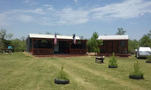 a view of a house with patio and a garden