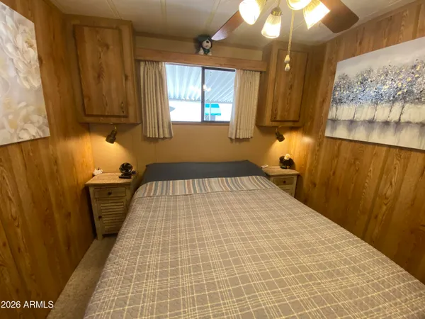 a bedroom with a bed and a chandelier