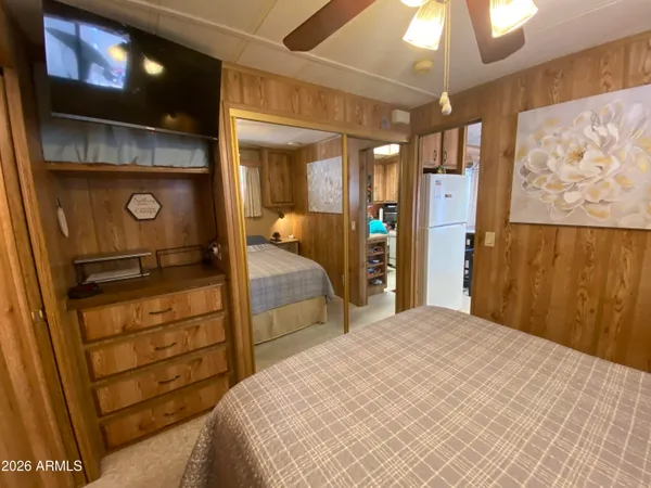 a bedroom with a bed and a chandelier