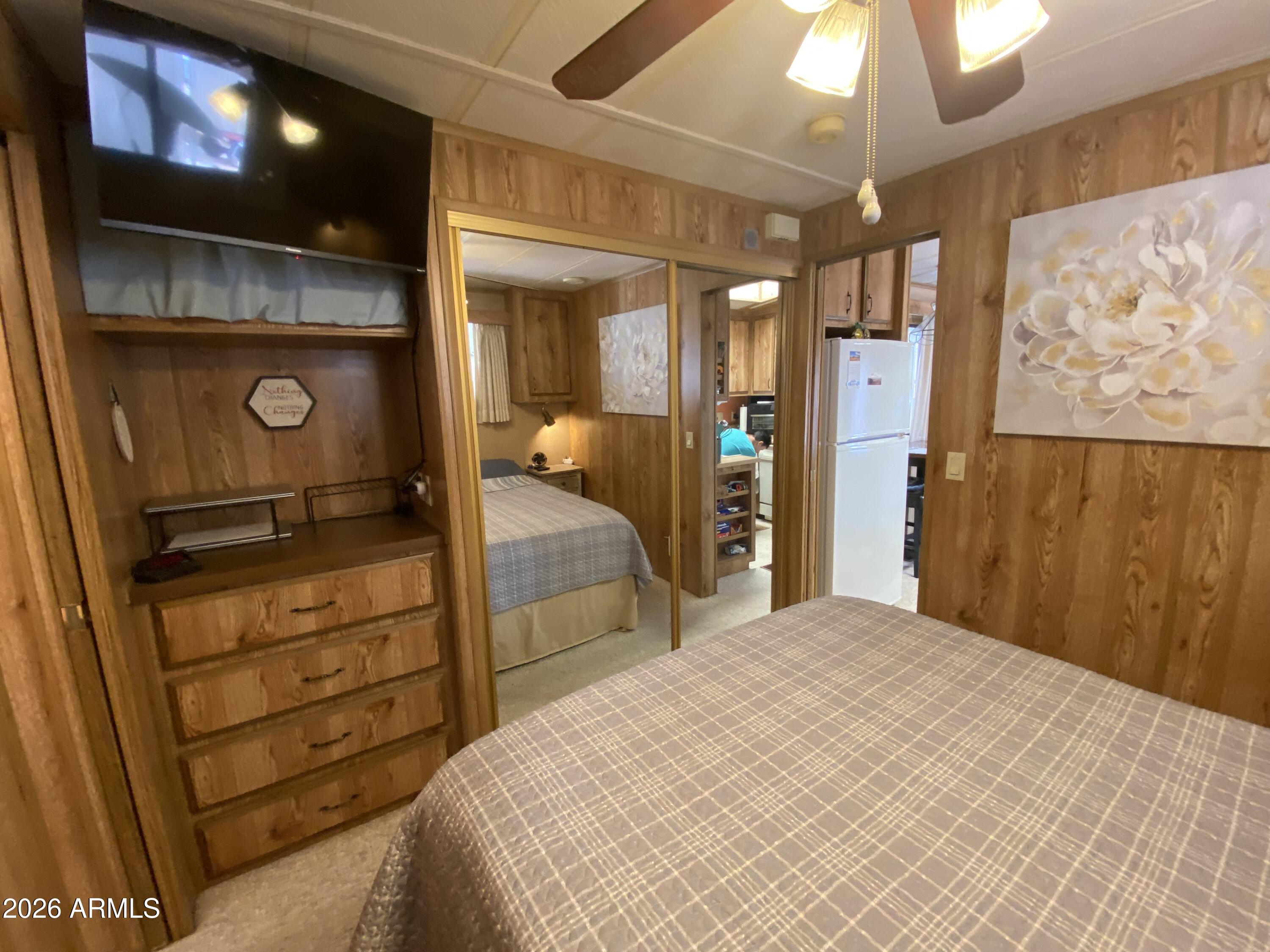 1340 West Inuit Avenue Apache Junction, AZ 85119 - Photo 12 of 30 a bedroom with a bed and a chandelier