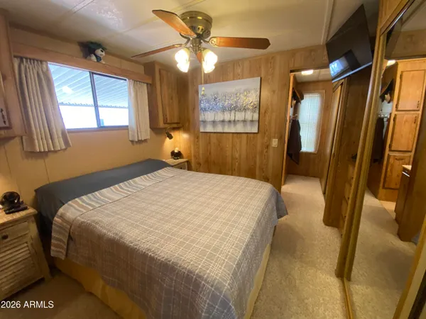 a bedroom with a bed dresser and a window