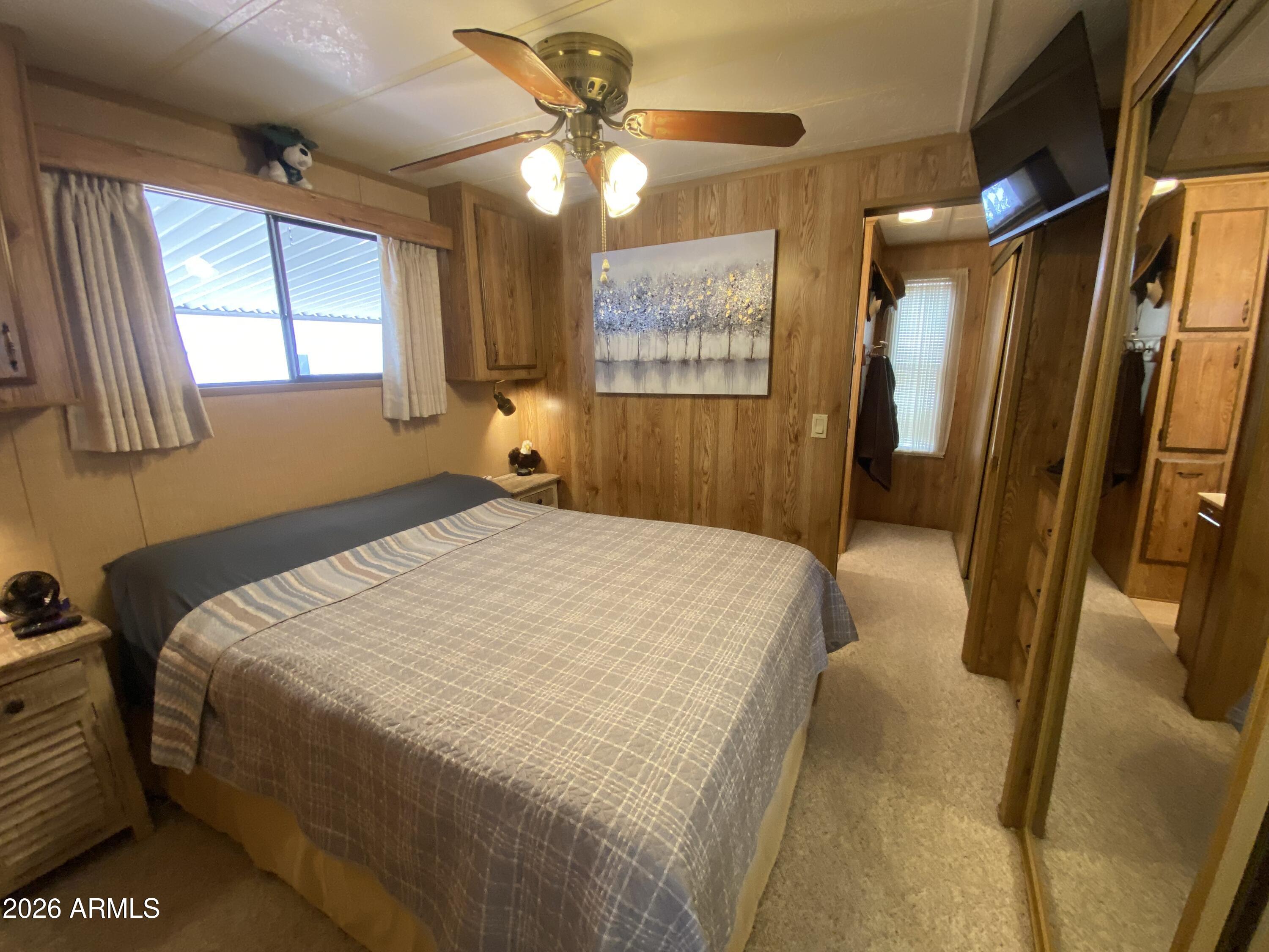 1340 West Inuit Avenue Apache Junction, AZ 85119 - Photo 13 of 30 a bedroom with a bed dresser and a window