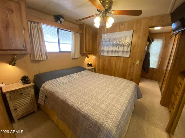 a bedroom with a bed and a mirror