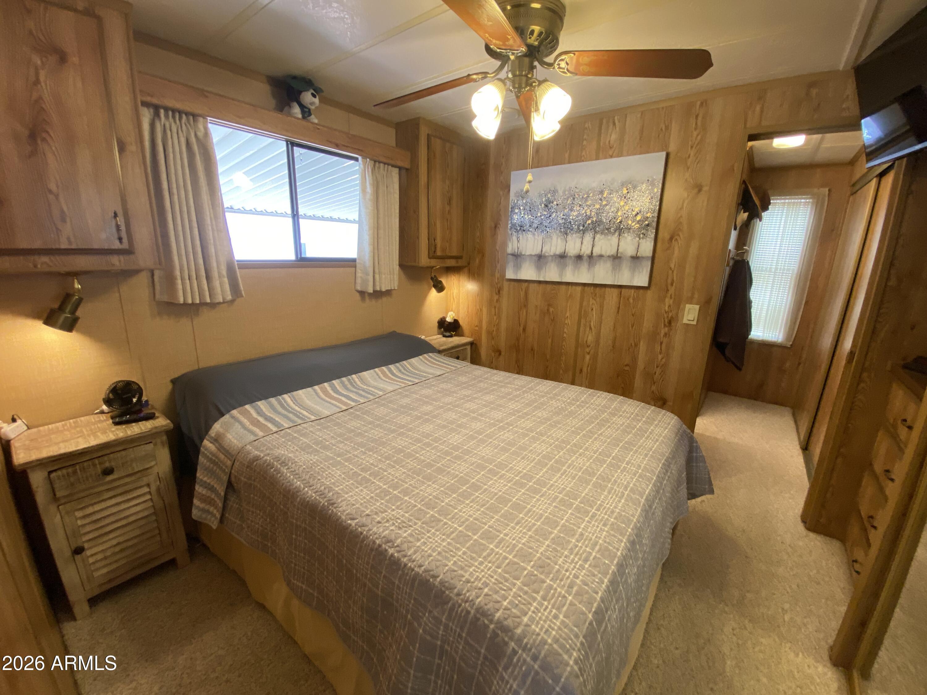 1340 West Inuit Avenue Apache Junction, AZ 85119 - Photo 14 of 30 a bedroom with a bed and a mirror