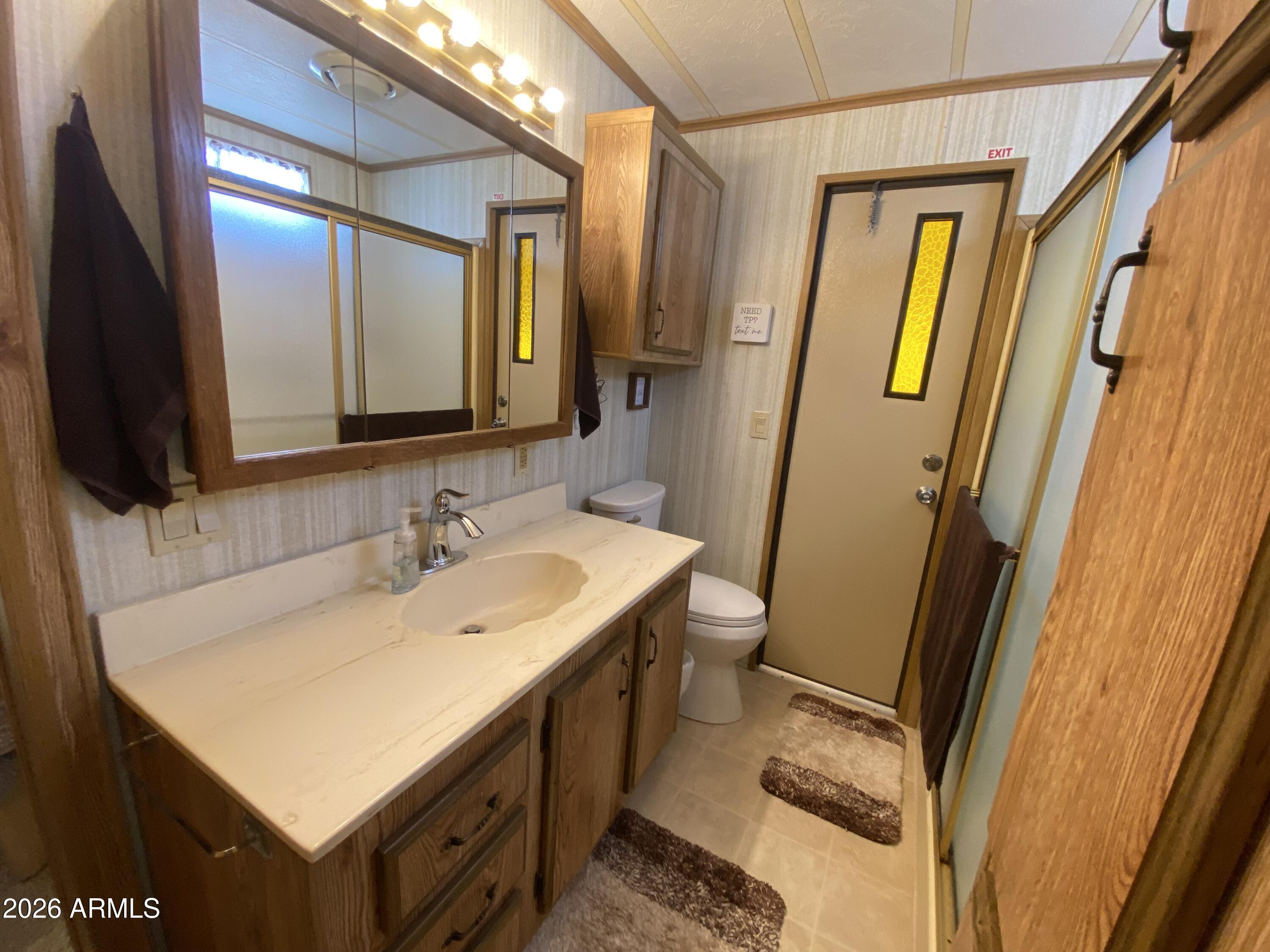 1340 West Inuit Avenue Apache Junction, AZ 85119 - Photo 15 of 30 a bathroom with a sink and a mirror