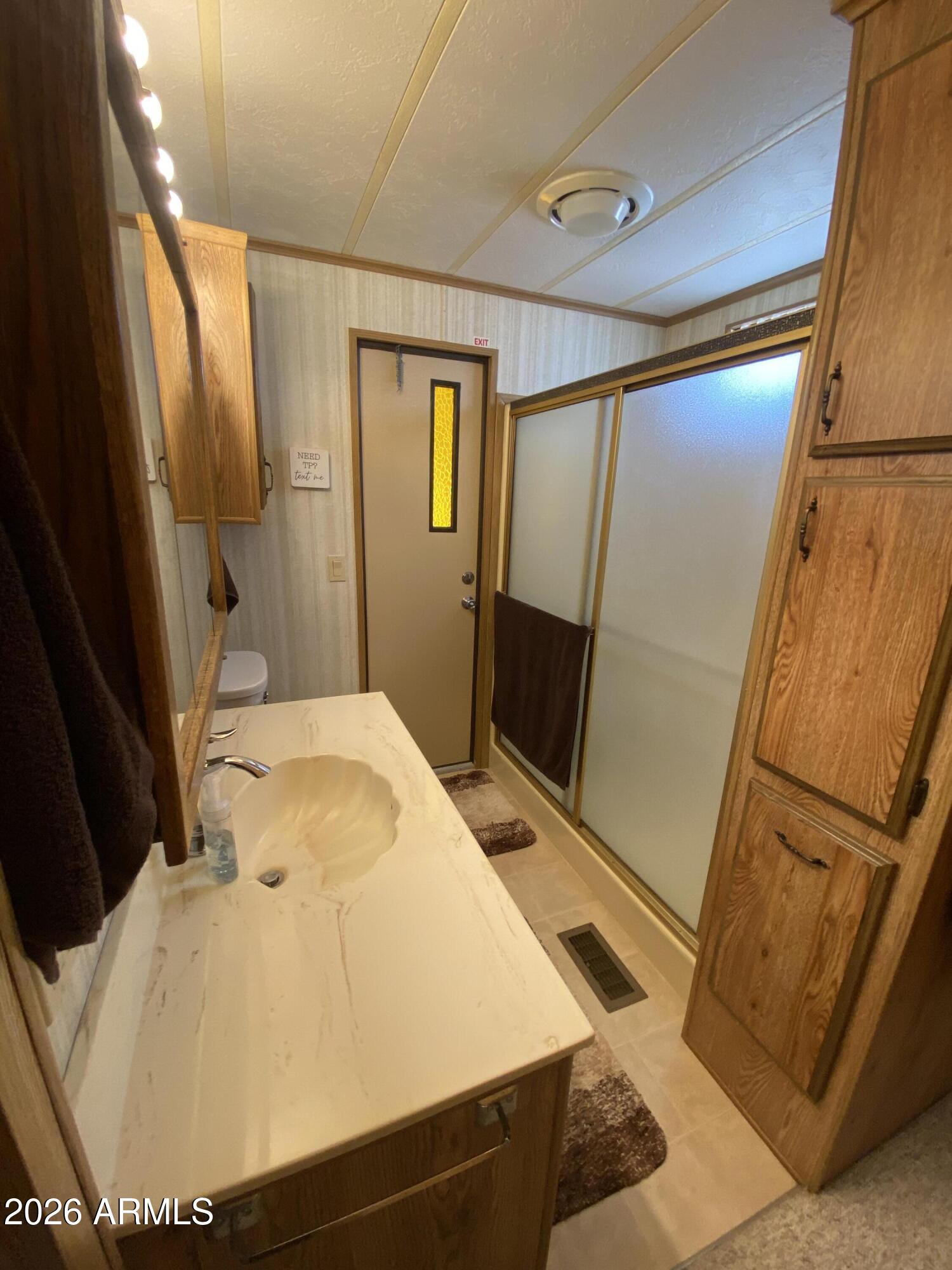 1340 West Inuit Avenue Apache Junction, AZ 85119 - Photo 17 of 30 a bathroom with a tub and shower