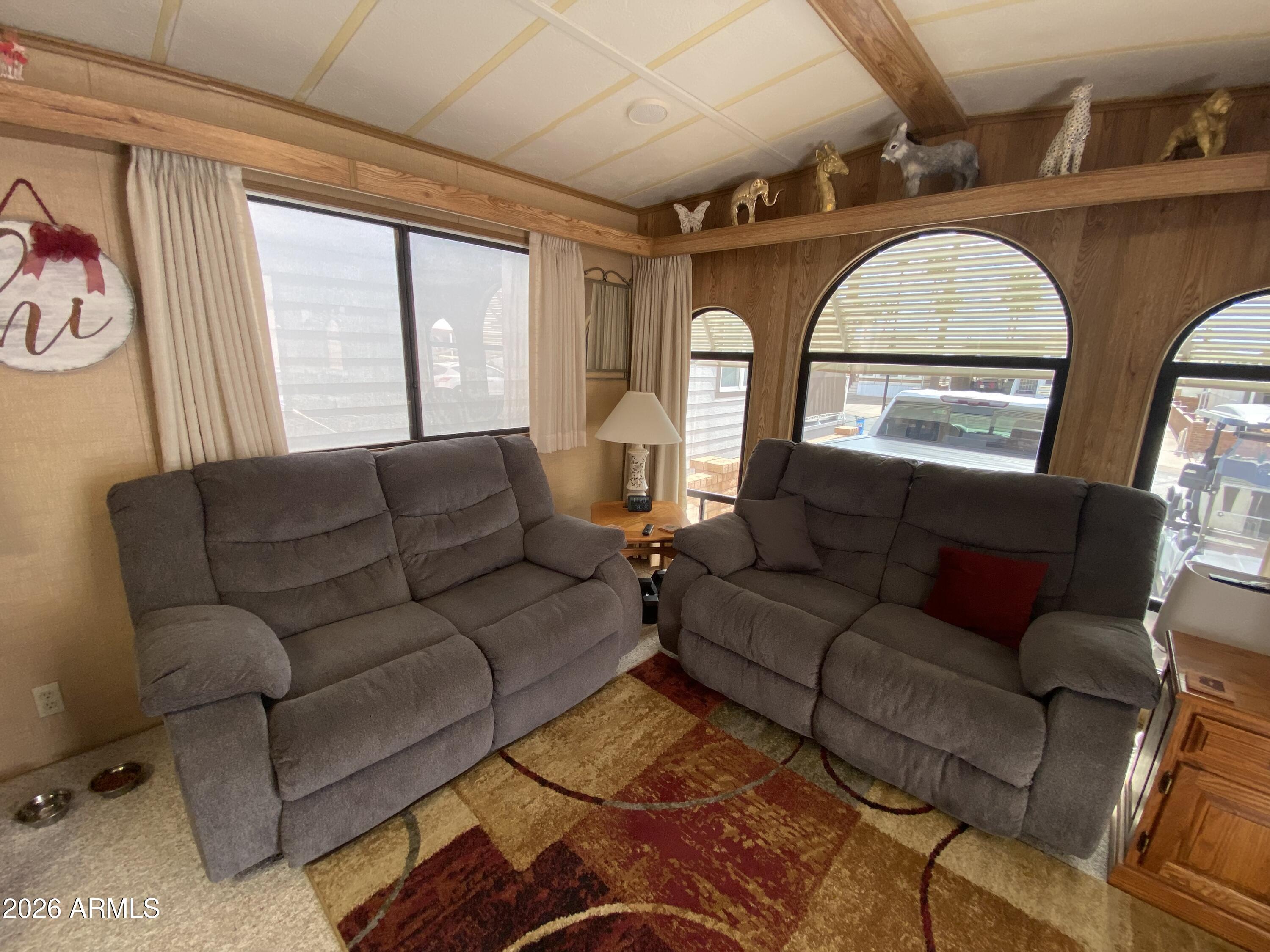 1340 West Inuit Avenue Apache Junction, AZ 85119 - Photo 2 of 30 a living room with furniture and a large window