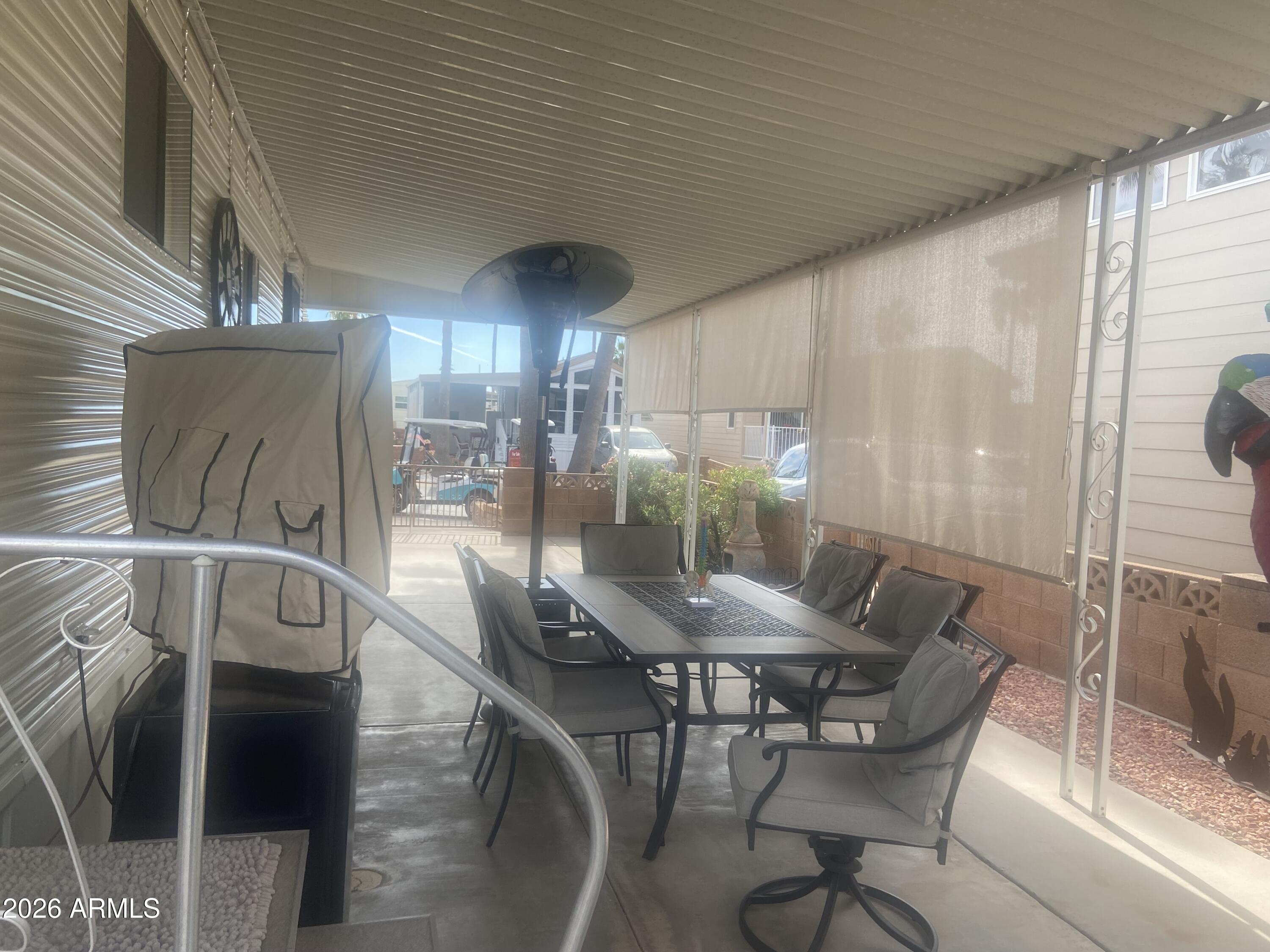 1340 West Inuit Avenue Apache Junction, AZ 85119 - Photo 23 of 30 a view of a dining room with furniture and chandelier