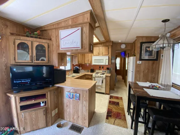 a open kitchen with stainless steel appliances granite countertop a stove and a refrigerator