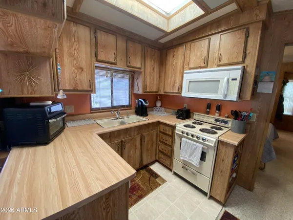 a kitchen with a stove a sink and a microwave