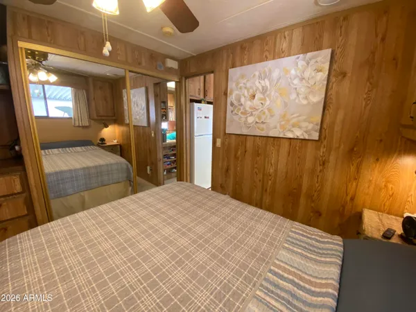 a bedroom with a large bed and a chandelier