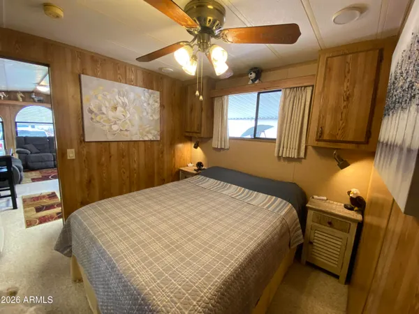 a bed sitting in a bedroom next to a window