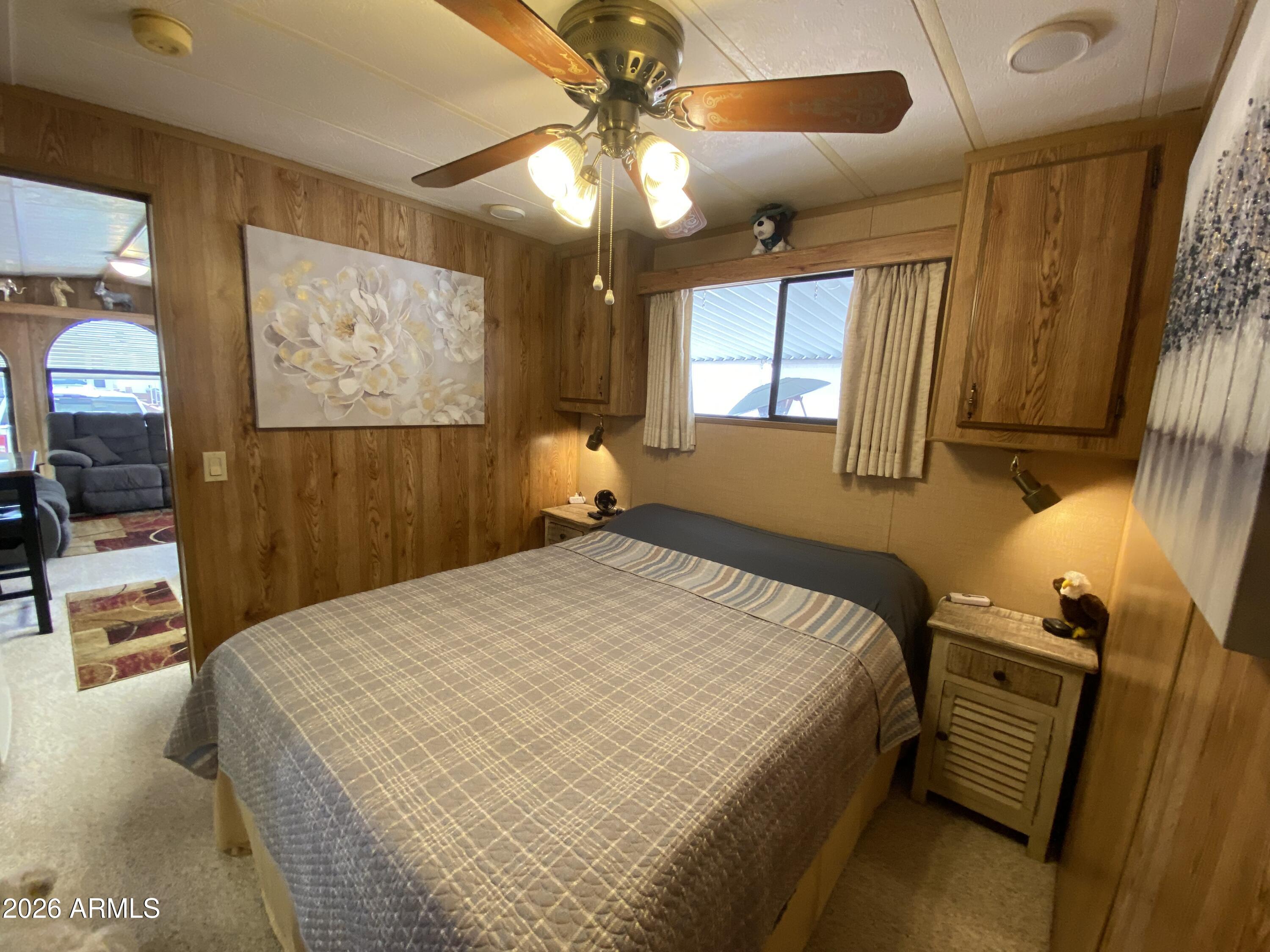 1340 West Inuit Avenue Apache Junction, AZ 85119 - Photo 10 of 30 a bed sitting in a bedroom next to a window