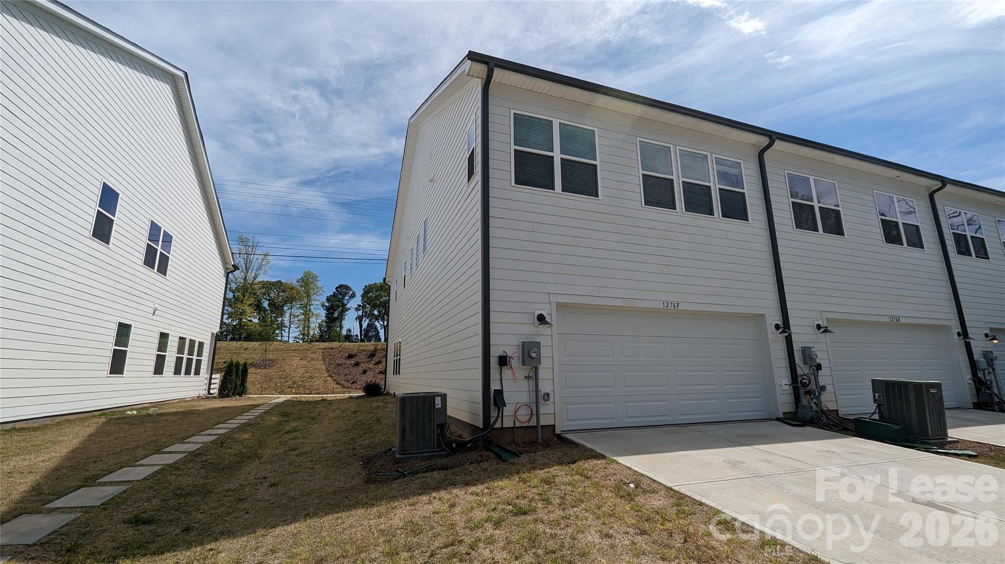 1276 Brawley School Road, Unit F Mooresville, NC 28117 - Photo 19 of 21 a view of a house with a backyard