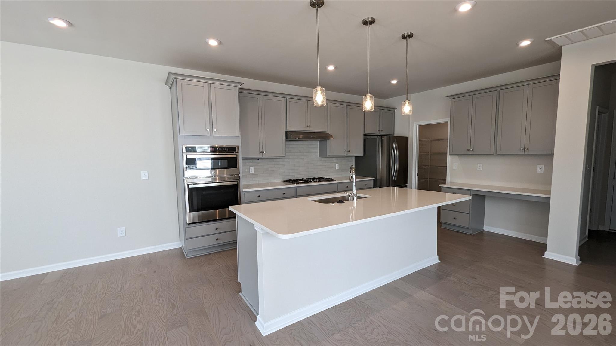 1276 Brawley School Road, Unit F Mooresville, NC 28117 - Photo 4 of 21 a large kitchen with a sink and stainless steel appliances