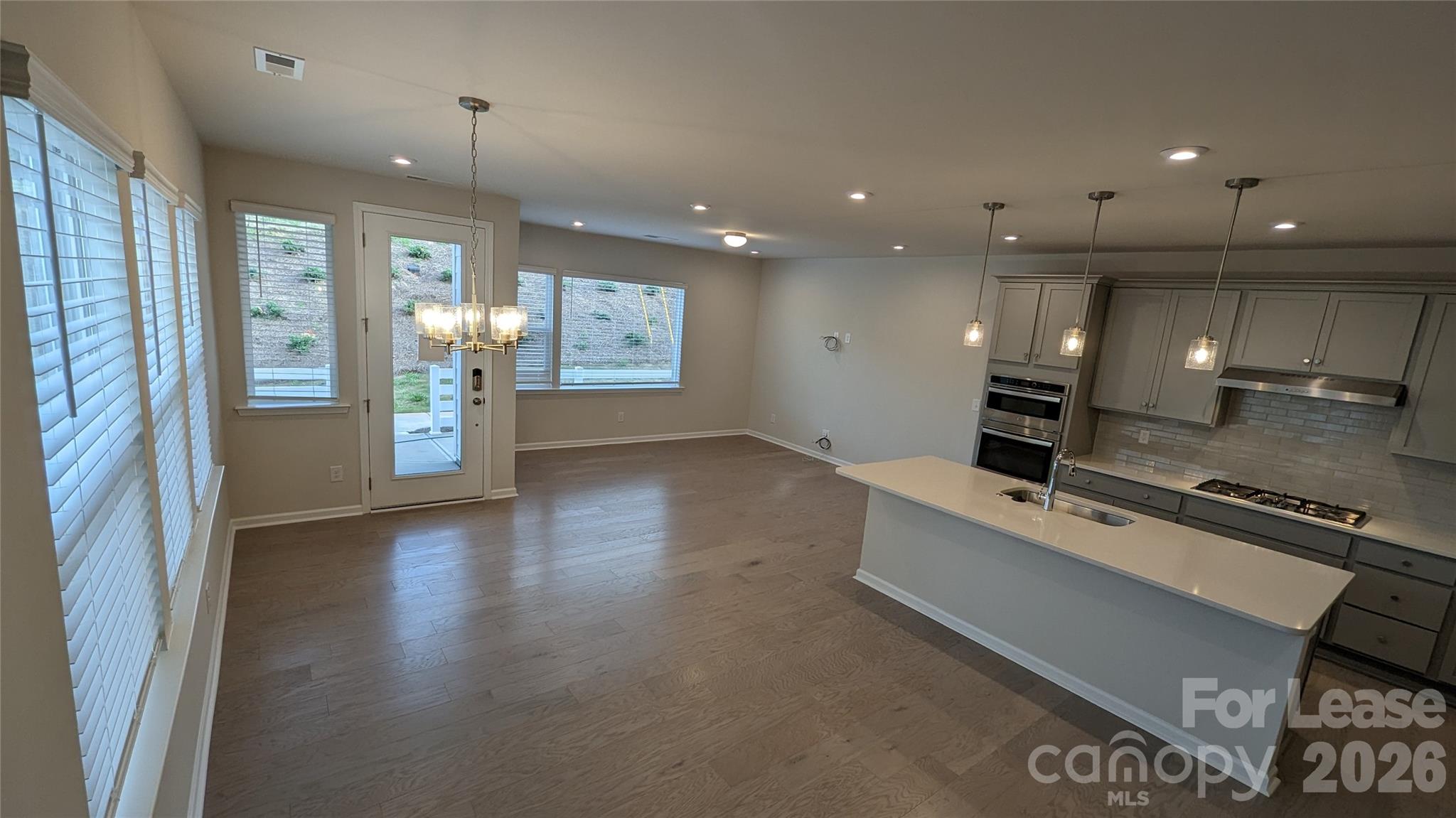 1276 Brawley School Road, Unit F Mooresville, NC 28117 - Photo 6 of 21 a view of kitchen with cabinets and wooden floor