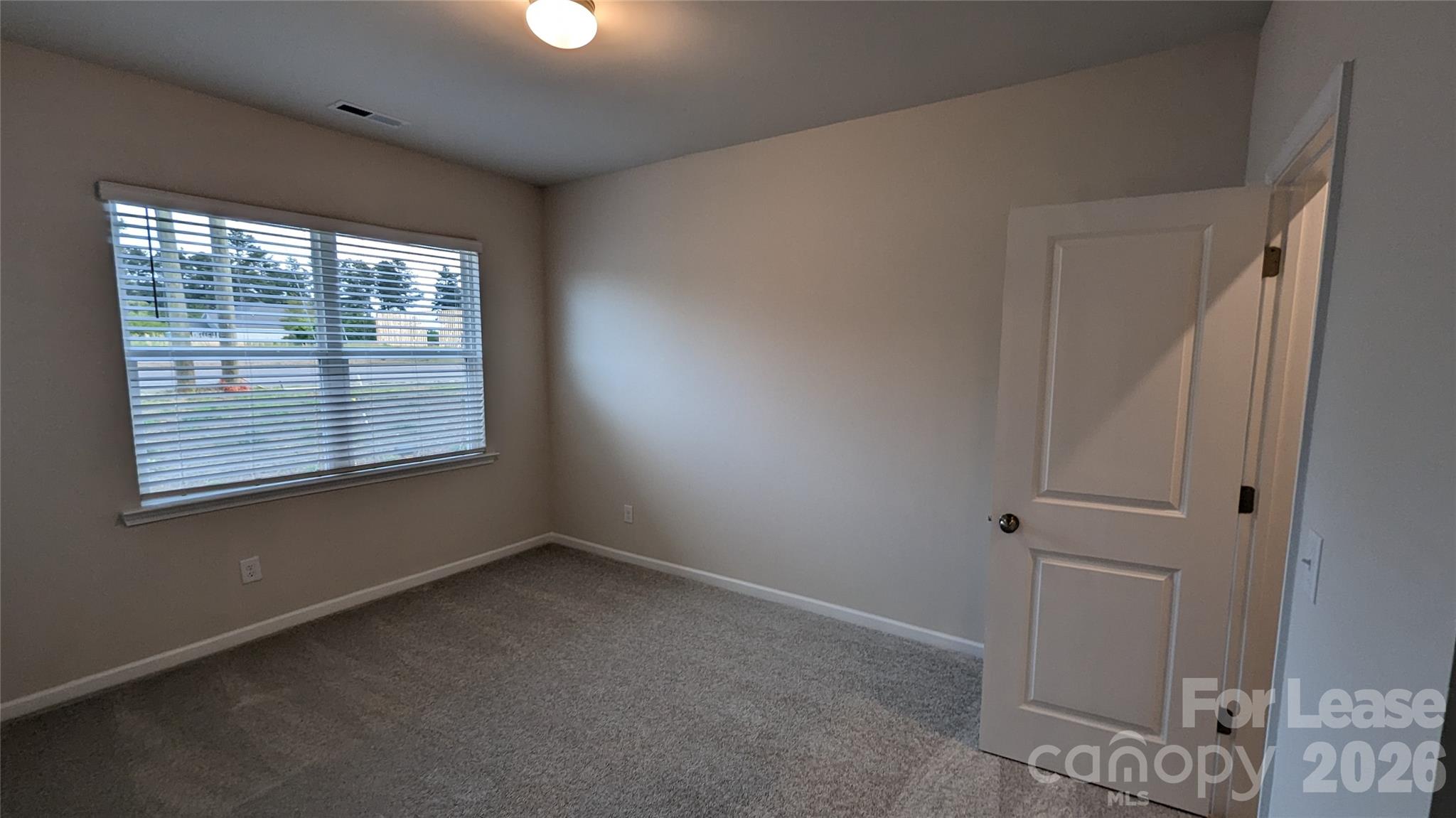 1276 Brawley School Road, Unit F Mooresville, NC 28117 - Photo 7 of 21 a view of an empty room with a window