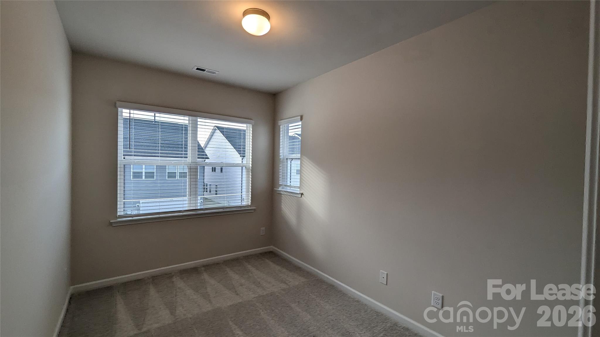 1276 Brawley School Road, Unit F Mooresville, NC 28117 - Photo 8 of 21 an empty room with windows