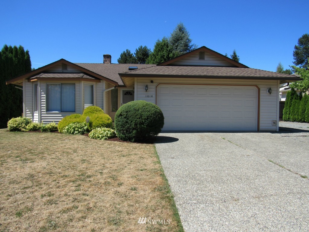 1014 207th Place Southeast Bothell, WA 98012 - Photo 1 of 25 a front view of a house with a yard and garage