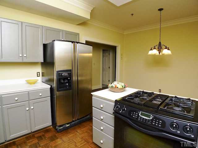 1612 Oberlin Road, Unit 7 Raleigh, NC 27608 - Photo 18 of 25 Solid surface counters with upgraded appliances and freshly painted wood cabinets.