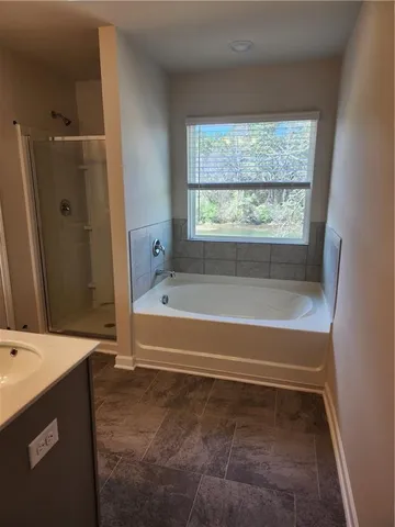 a bathroom with a bathtub and a shower