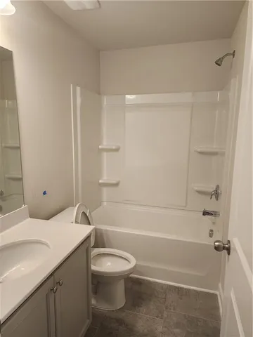 a bathroom with a toilet a sink and bathtub